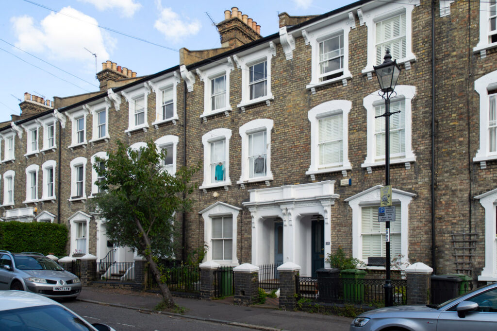 A photograph showing some narrow terraced houses.