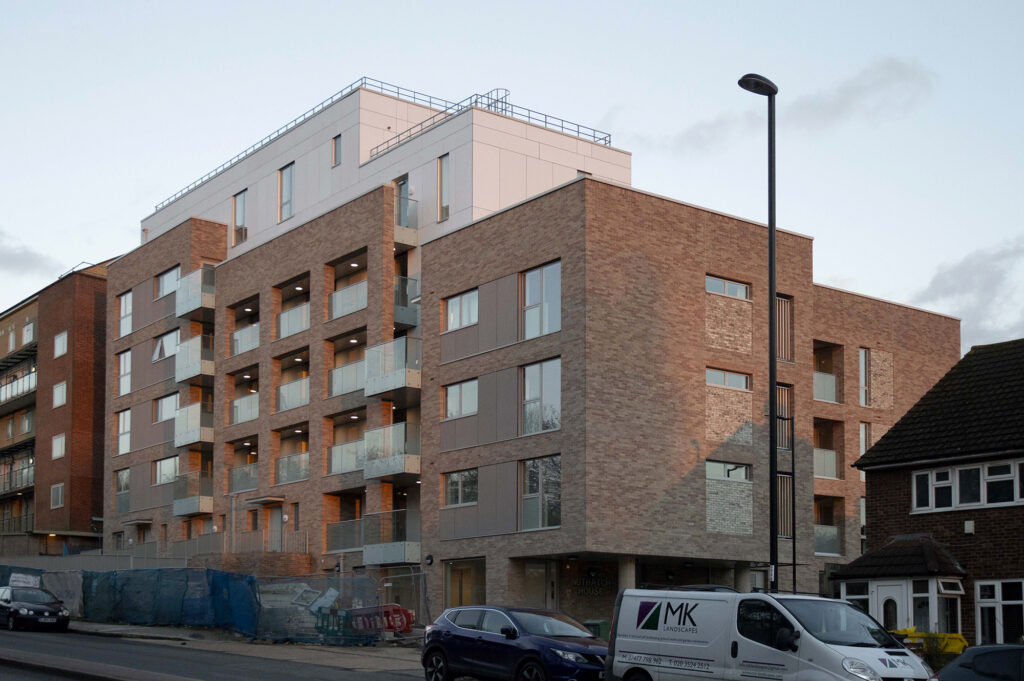 A photograph of a large, blocky residential development.