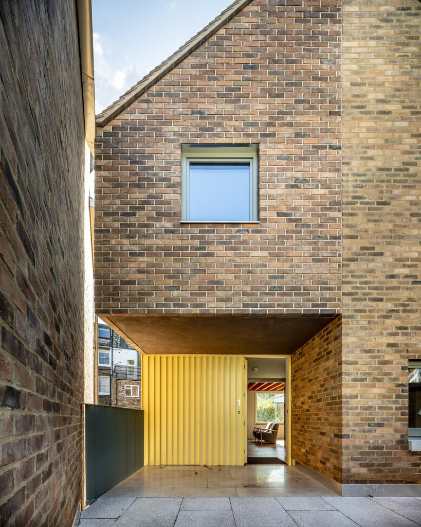 A contemporary brick house with an unusual entrance.