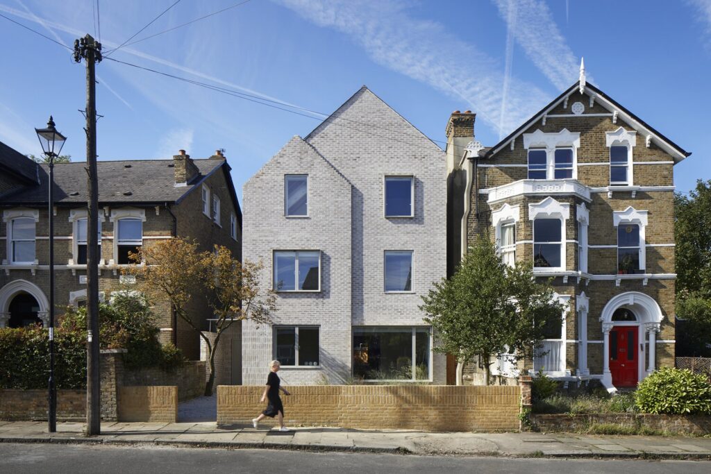 A photograph of a contemporary extension that mimics the existing streetscape