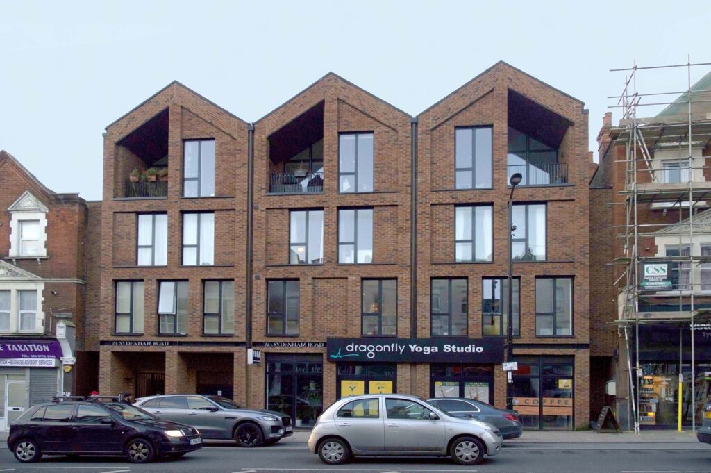 Photograph of a building on a high street with a pitched roof