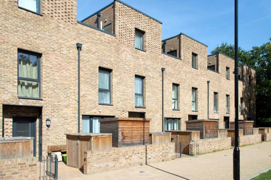A photograph of a terrace of contemporary brick houses